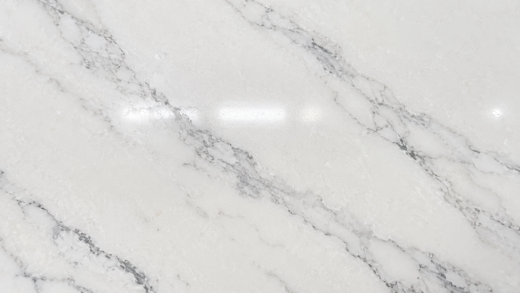 Close-up of a premium quartz stone slab showing veining and polished surface texture
