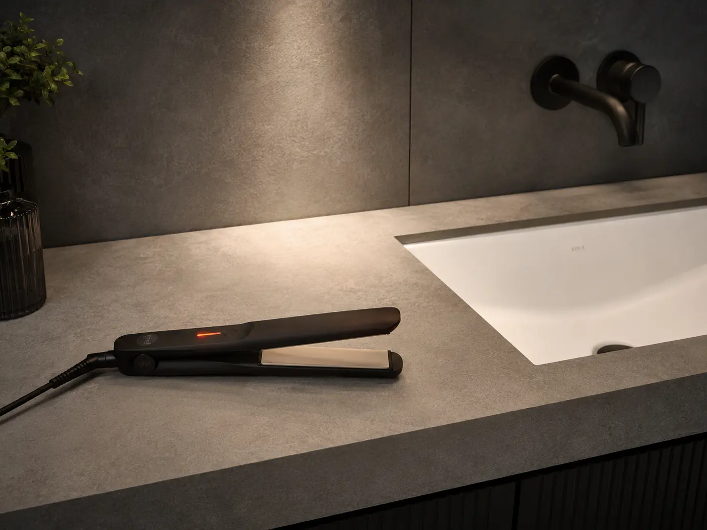 Matte sintered stone bathroom vanity top with hair straightener placed directly on the surface, demonstrating heat resistance Matte sintered stone bathroom vanity top with hair straightener placed directly on the surface, demonstrating heat resistance