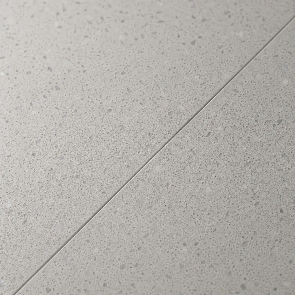 Close-up of a nearly invisible seam line joining two pieces of quartz stone countertop Close-up of a nearly invisible seam line joining two pieces of quartz stone countertop